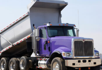 purple dump truck at a construction site