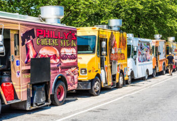 colorful food trucks lined up at a food festival