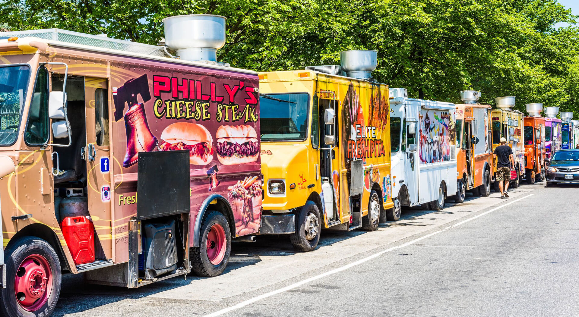 colorful food trucks lined up at a food festival