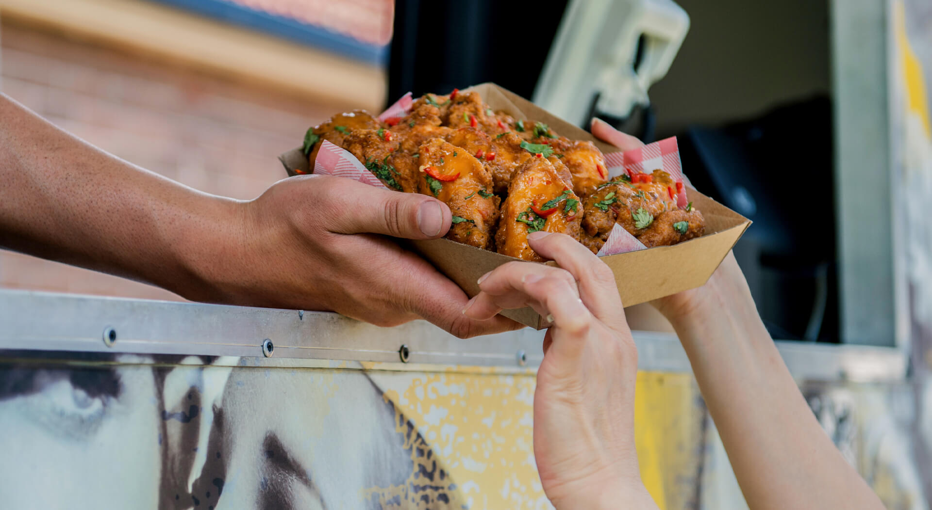 food truck customer at a food truck getting chicken wings order