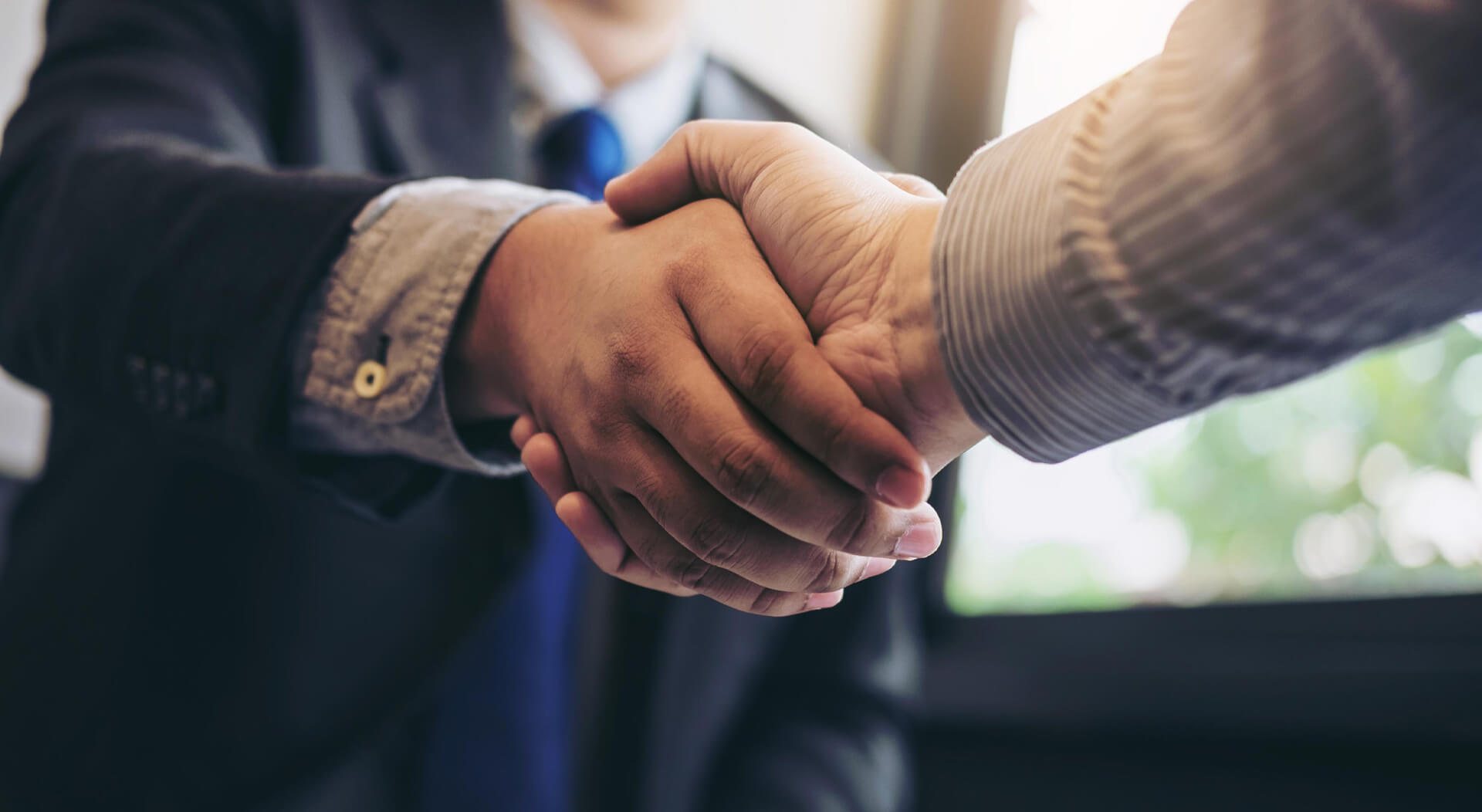 business men shaking hands during a meeting to sell truck