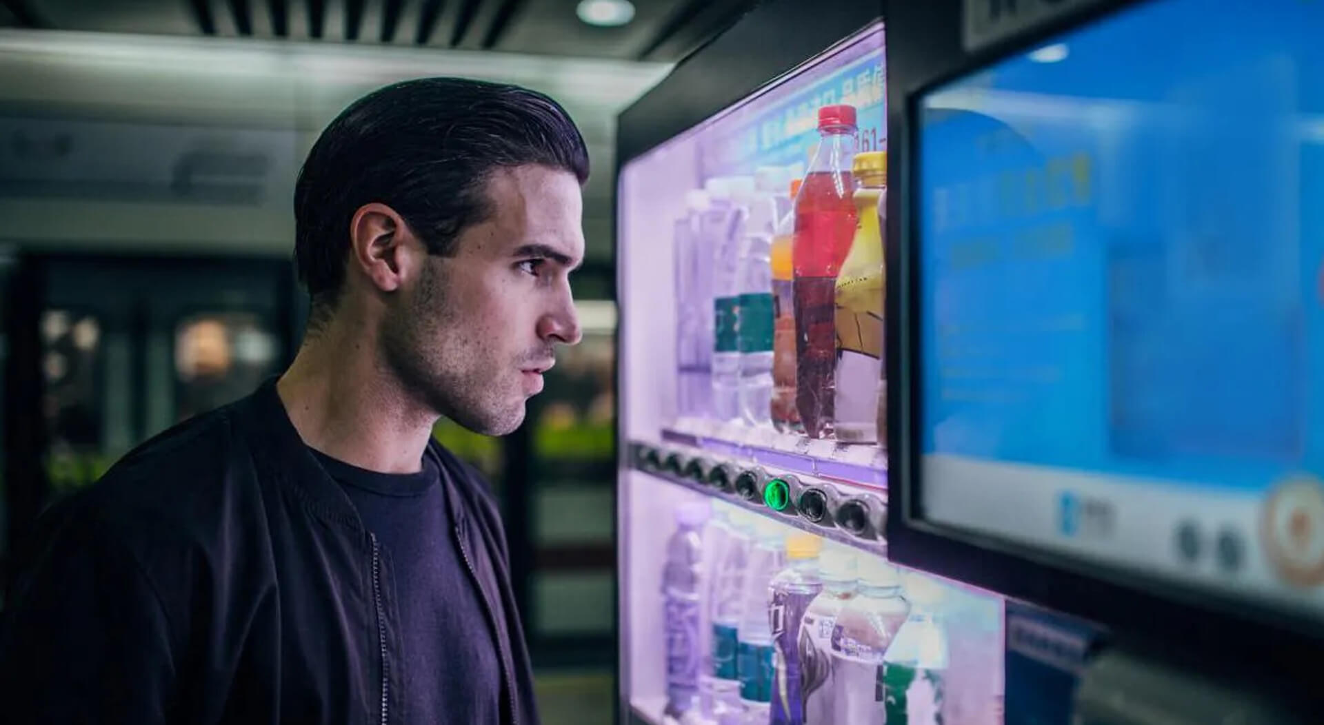 young guy using a vending machine