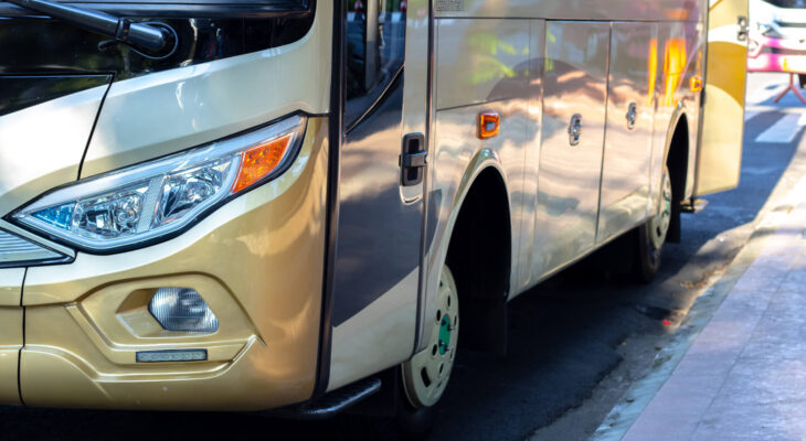 white and gold colored conversion bus on the side of the road