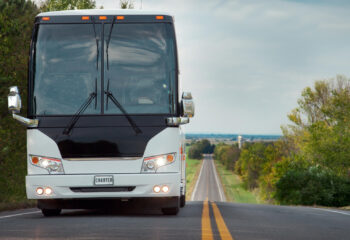 white charter coach bus on a highway