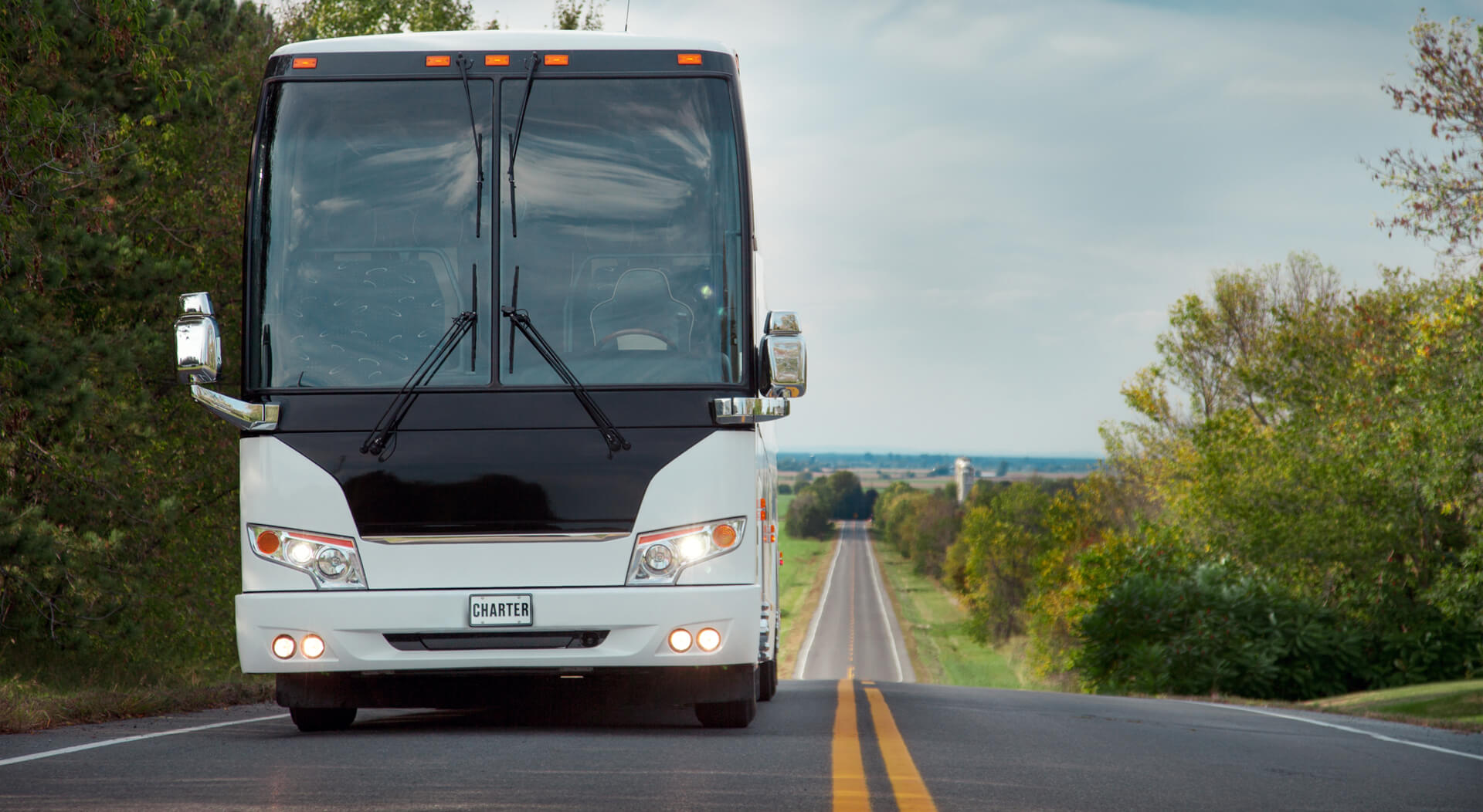 white charter coach bus on a highway