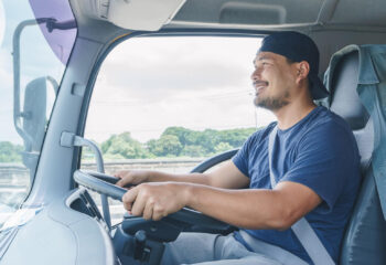 young professional truck driver driving a semi truck