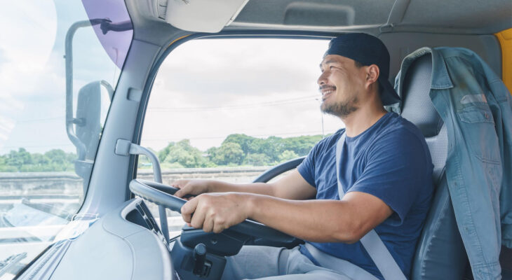 young professional truck driver driving a semi truck