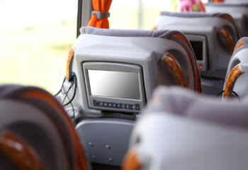 small television at the back of the headrest of a luxury bus' chair