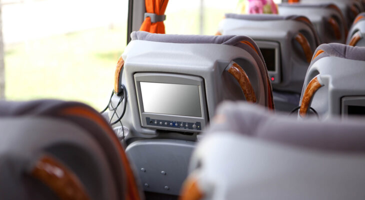 small television at the back of the headrest of a luxury bus' chair