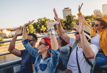 group of tourists touring a city in a party bus