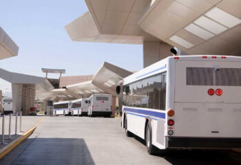 shuttle buses lined up for customers at an airport