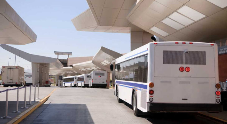 shuttle buses lined up for customers at an airport