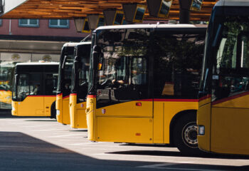 group of buses lined up at a bus rental business