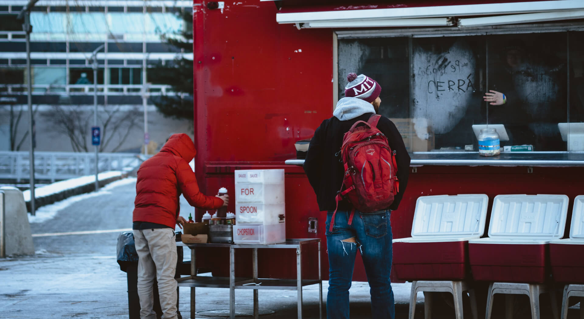 two persons at a food truck during winter