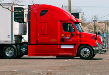 red and white truck on the road during daytime