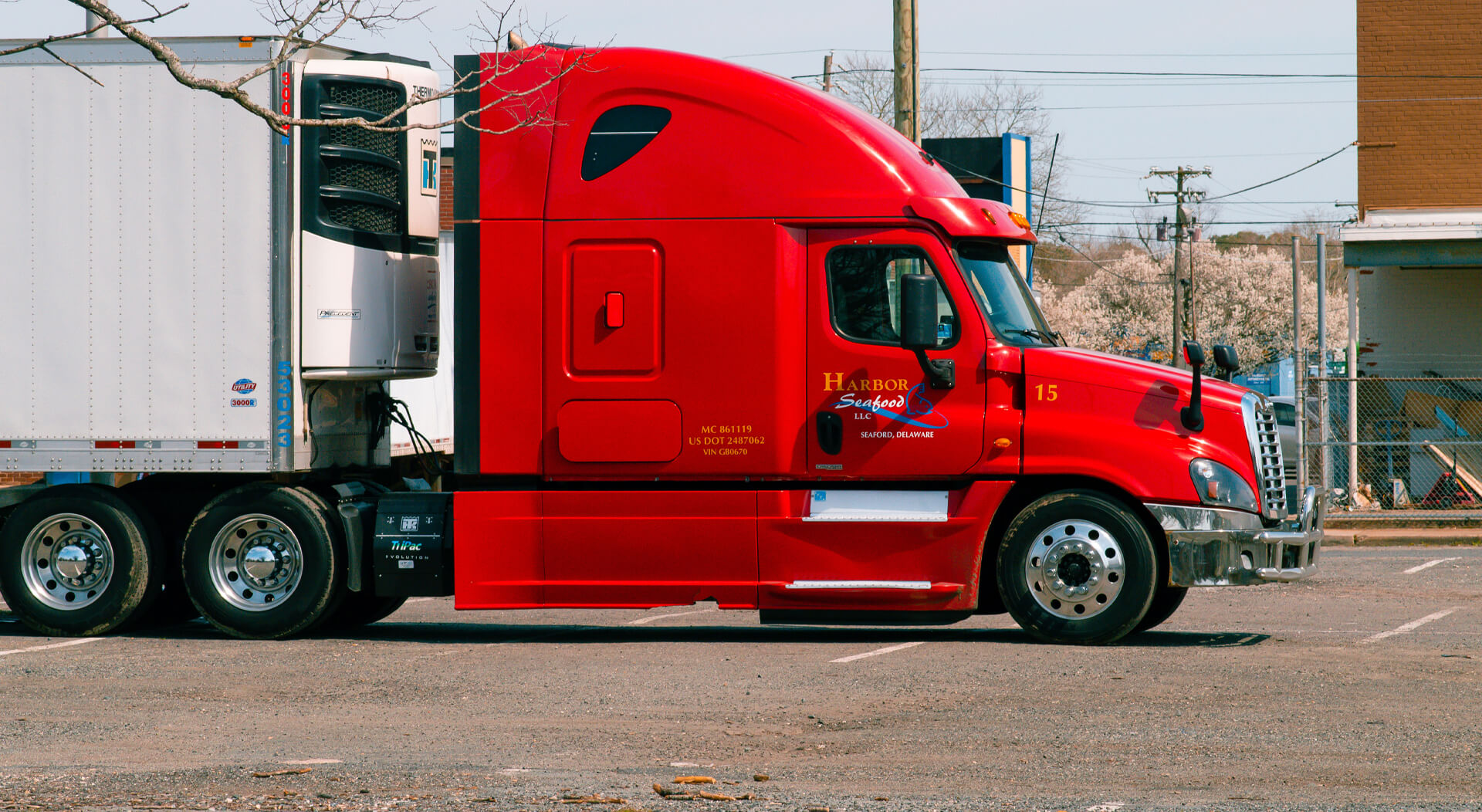 red and white truck on the road during daytime