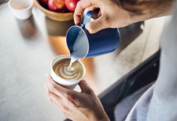 food truck server serving cappuccino at a breakfast food truck