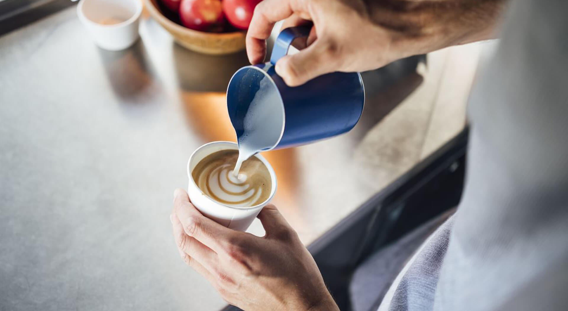 food truck server serving cappuccino at a breakfast food truck