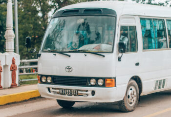 white mini bus on a road