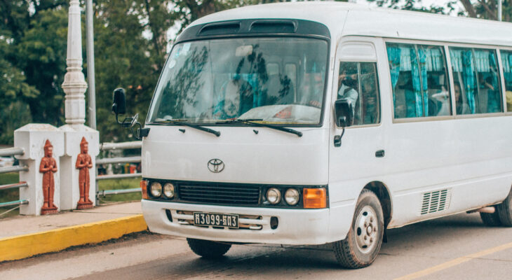 white mini bus on a road