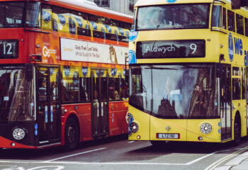 two double decker buses at a busy intersection