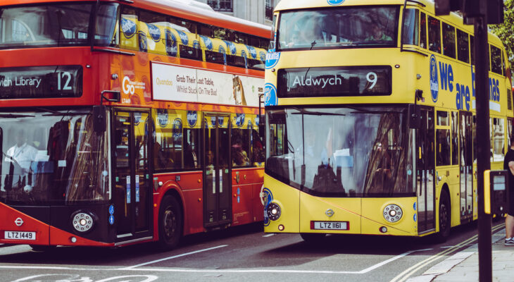 two double decker buses at a busy intersection