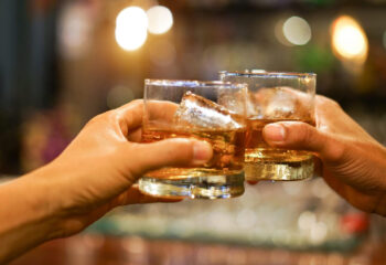 two friends having whiskey at a mobile bar