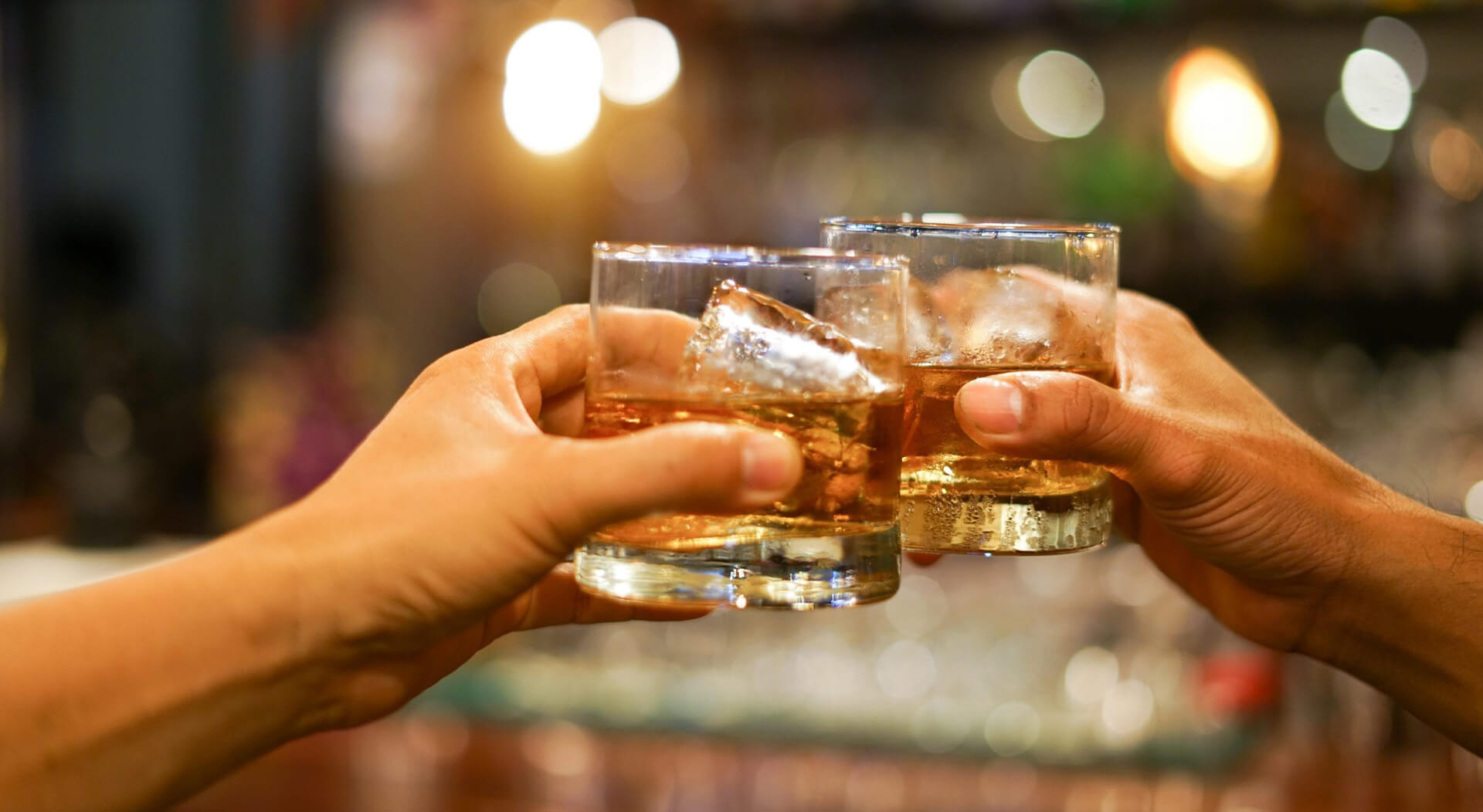 two friends having whiskey at a mobile bar