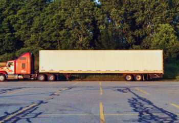 red semi truck parked on a truck parking lot