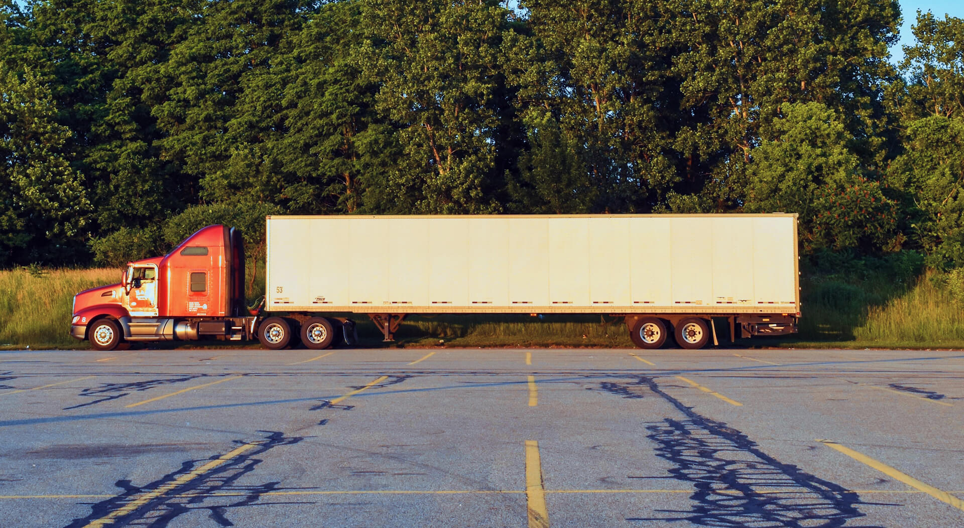 red semi truck parked on a truck parking lot