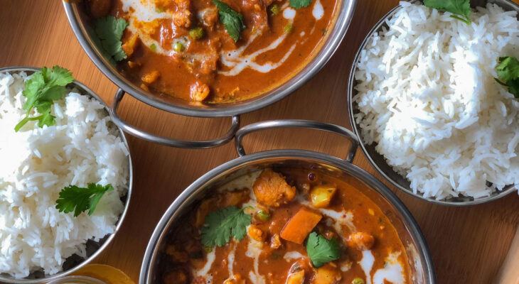 indian food set up at a table outside an indian food truck