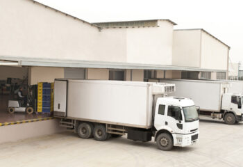 white semi truck at a truck loading dock