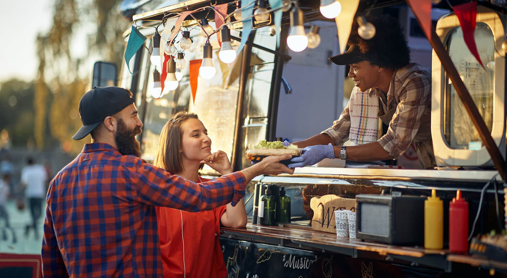 food truck employee handing out an order to a customer