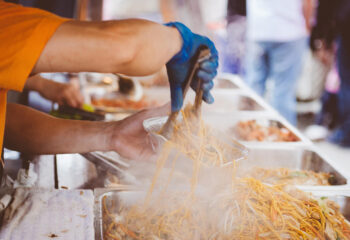 food truck attendant serving chinese food to customers