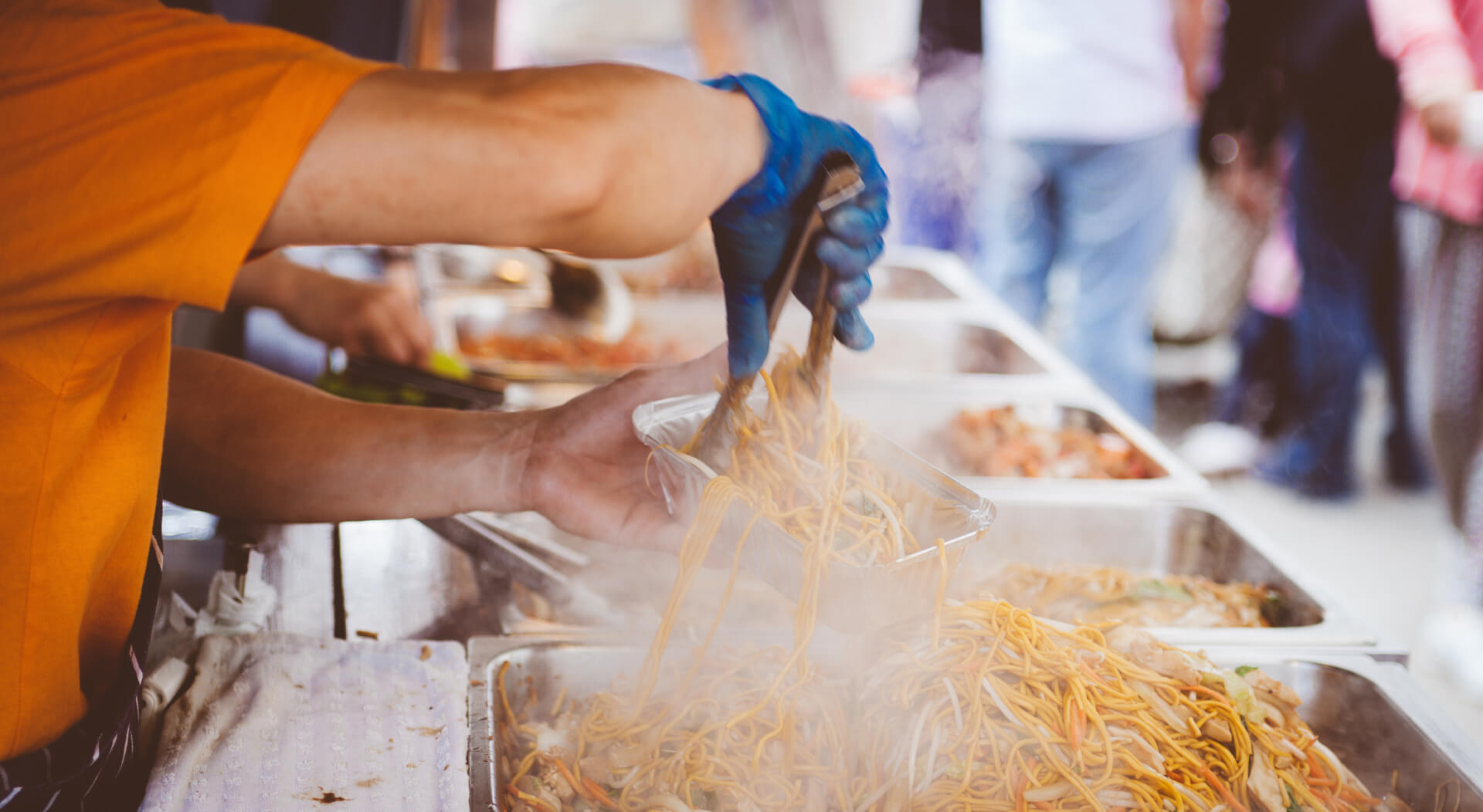 food truck attendant serving chinese food to customers