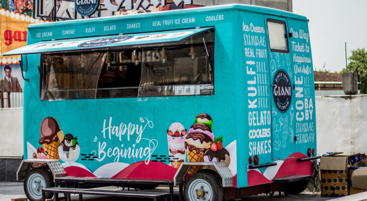 a teal food truck selling ice cream parked without an attendant