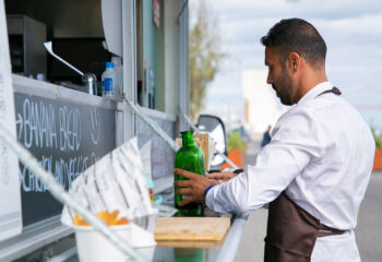 food truck server arranging bottles on the food truck counter