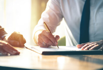 buyer and seller signing a sales contract