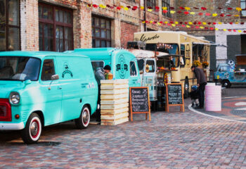 group of food trucks lined up in a street