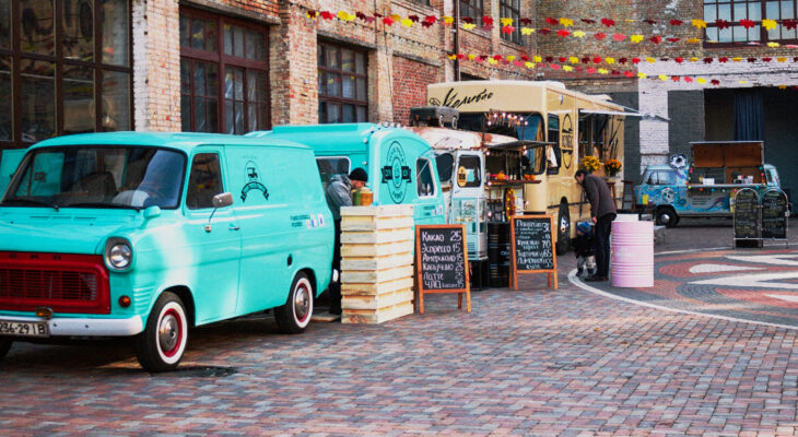 group of food trucks lined up in a street