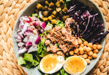 healthy salad bowl in a braided table mat