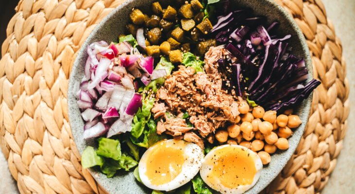 healthy salad bowl in a braided table mat