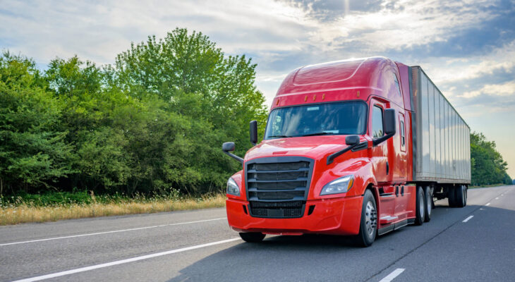 heavy loaded red semi truck transporting commercial cargo